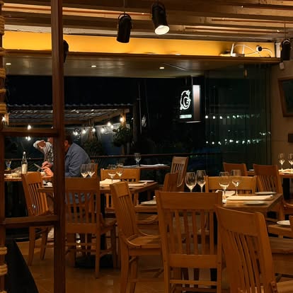 Warmly lit open-air dining area at El Refugio in the evening